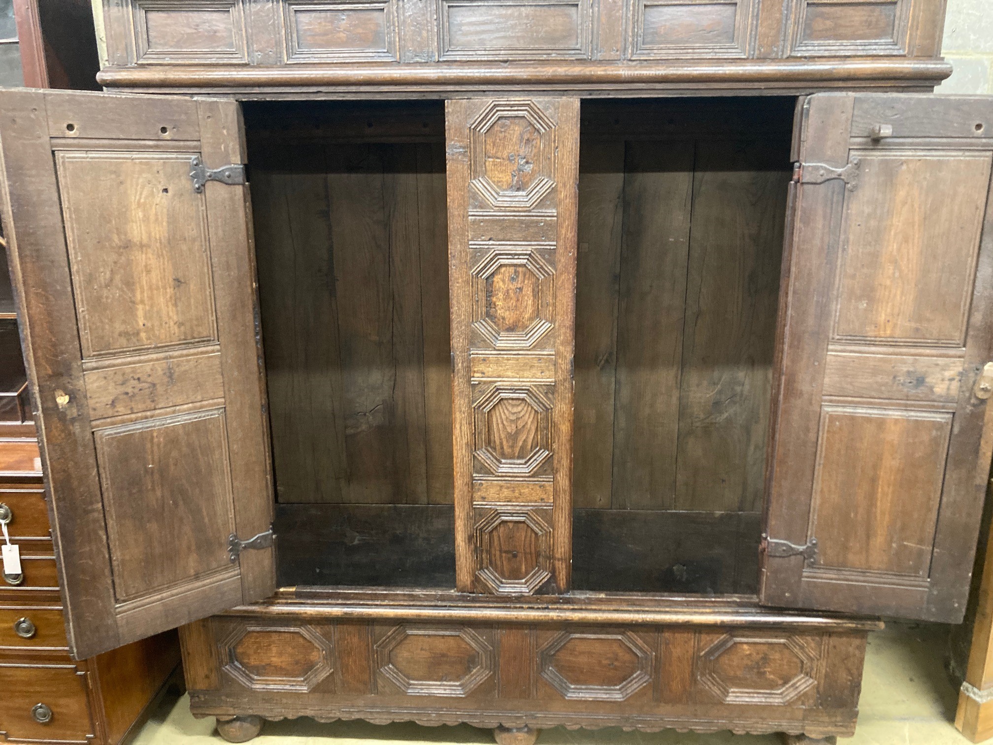 A 17th century and later panelled oak cupboard, length 194cm, depth 70cm, height 198cm